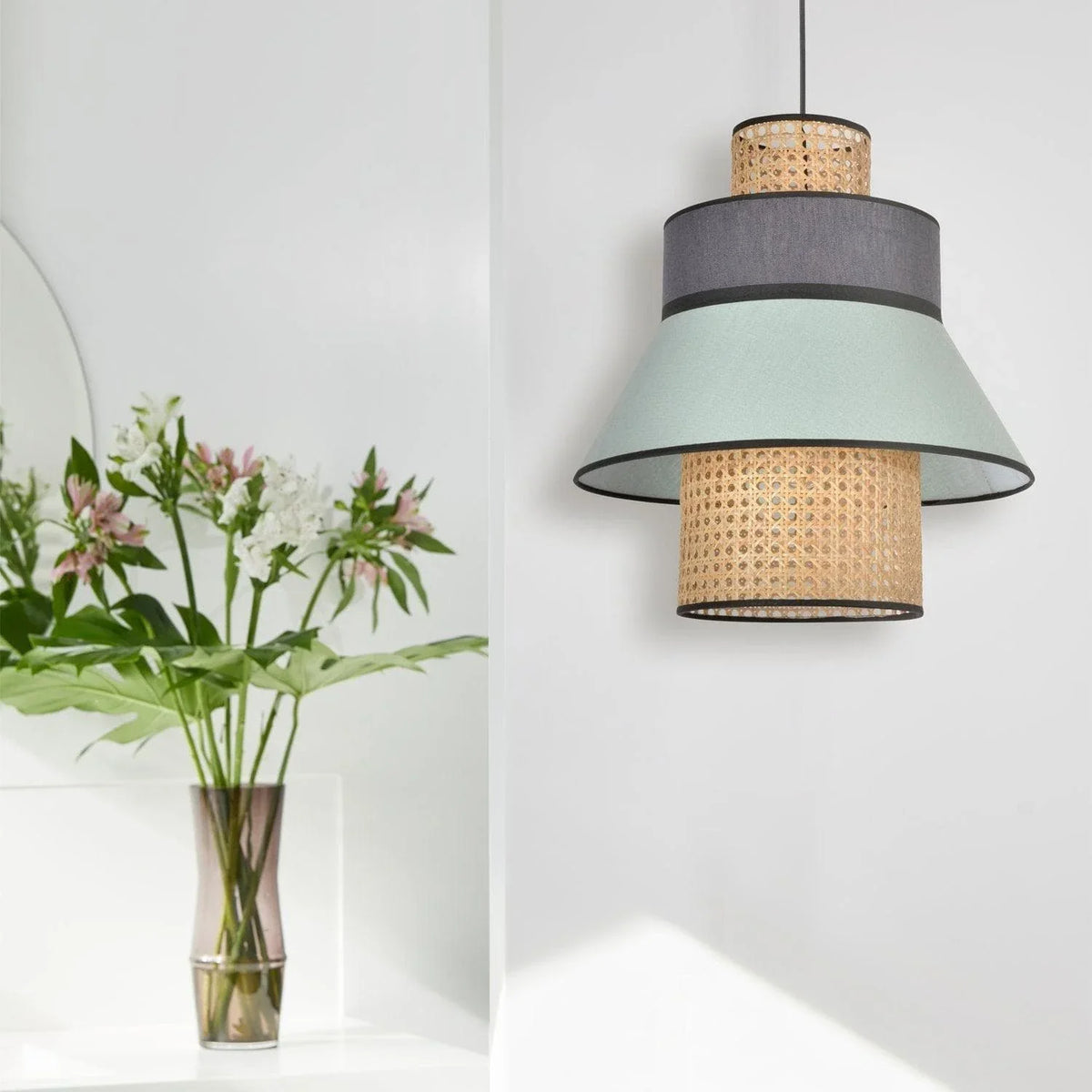 Modern layered pendant light with rattan and fabric shades, stylish home lighting