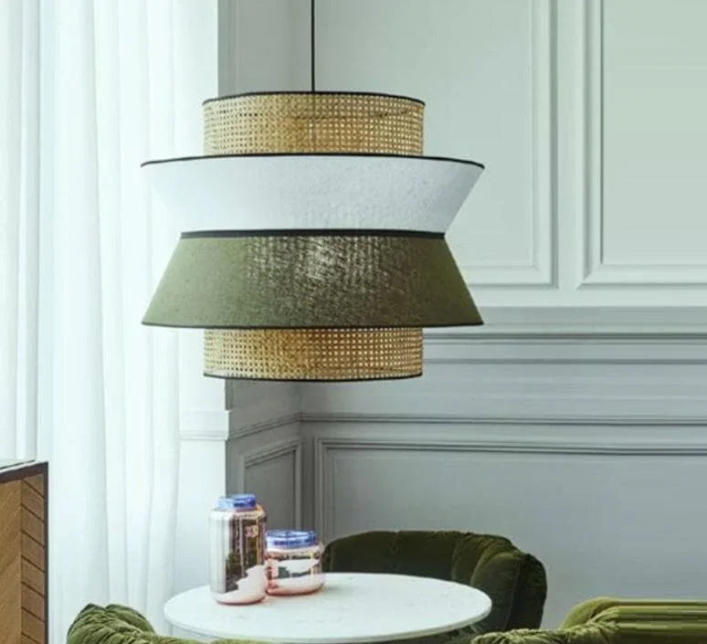 Modern layered pendant light with woven and fabric shades in a stylish dining space