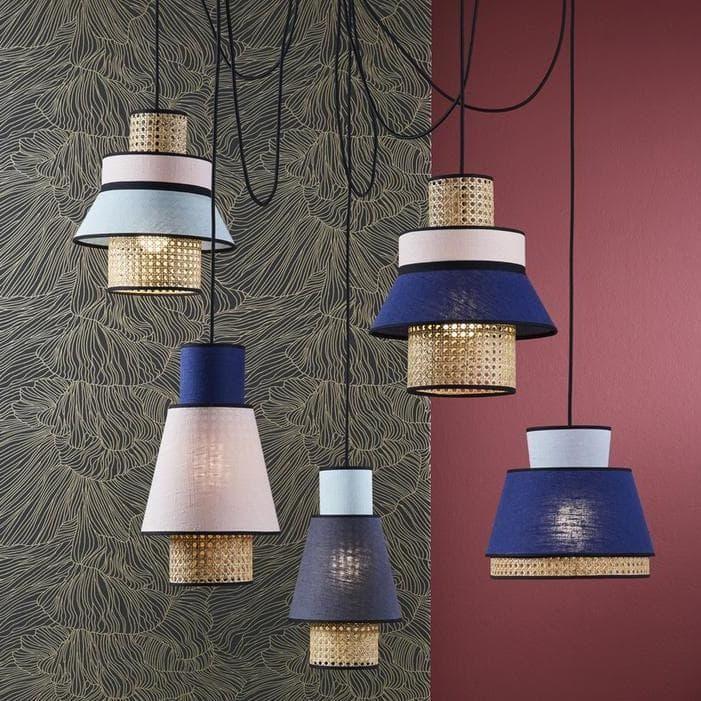 Modern pendant lights with woven gold bases and colorful fabric shades in blue, pink, and white