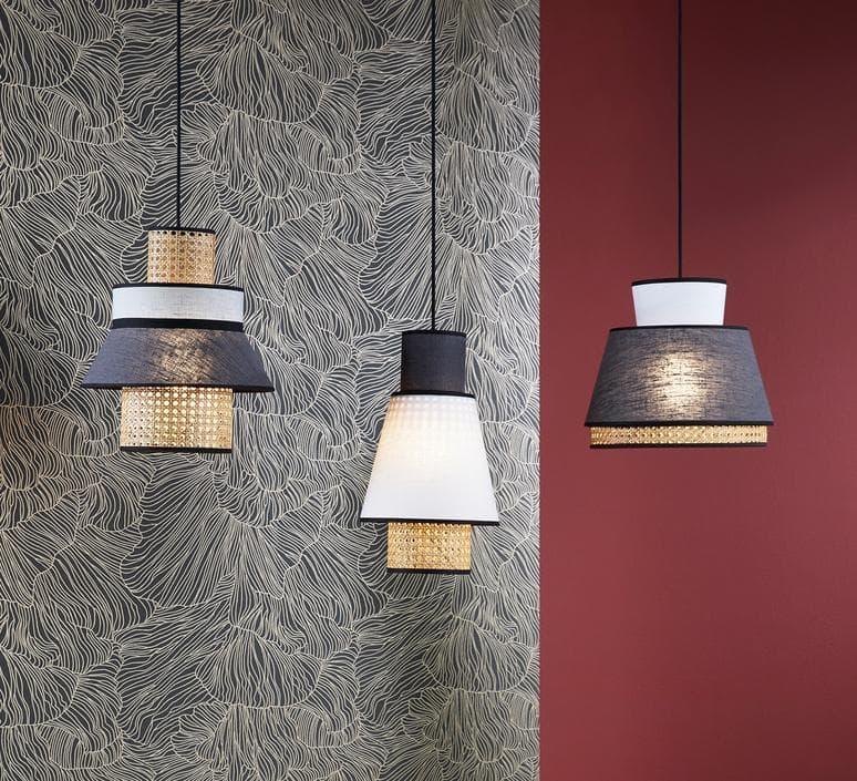 Modern pendant lights with woven gold bases and fabric shades, displayed against patterned and solid walls.